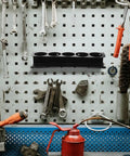 Heavy Duty Wall Mounted Spray Can Storage Rack And Metal Power Tool Organizer featuring a sleek design, holding tools against a pegboard.