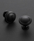 Dang Slick Matte Black Finish Round Cabinet Knobs Zinc Hardware on textured black surface, showcasing two sizes for easy upgrade.