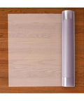 Top view of Premium Clear Floor Protector Mat 27 Inch By 12 Foot Waterproof Roll, partially unrolled on hardwood floor