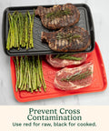 Grilling Prep And Serve Trays Set 17 x 10.5 Inch Dual Nesting Trays Red For Raw Meat And Black For Cooked Food shown with steak and asparagus.