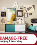 Living room wall with various frames hung using Damage-Free Picture Hanging Strips Set With 64 Strips For Large 15Lb, Medium 10Lb And Small 5Lb Frames, No Tools Required, No Nails Needed, White Adhesive Hangers For Home Wall Decor