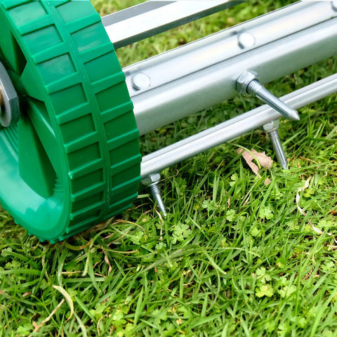 Close-up of Pro Grade Spike Lawn Aerator with heavy duty rolling design on grass, showcasing the 49 inch steel handle and spikes.