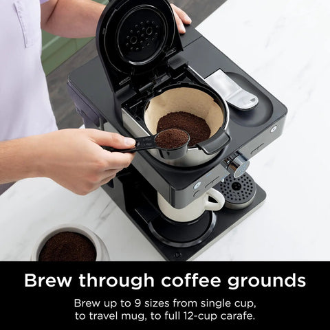 Espresso And Coffee Maker Barista System With Built In Frother Three Espresso Brew Styles Nespresso Capsule Compatible 19 Bar Pressure For Rich Crema At Home Cafe Quality Espresso Cappuccino And Latte Maker Black with coffee grounds being scooped into filter