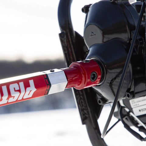 Close-up of Rock Solid Pistol Bit Adapter For Auger Powerheads mounted on engine, showcasing heavy-duty red finish.