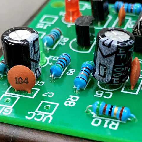 High Quality 1200 Piece Ceramic Capacitor Assortment Kit Featuring 60 Unique Values Spanning 1PF Up To 100NF Rated At 50V close-up of circuit board with capacitors and resistors.