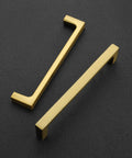Slick Brushed Brass Cabinet Pulls 5 Inch Center To Center Solid Metal Drawer Handles on black background.