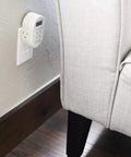 Smooth Operator Indoor Plug In Digital Timer With Two Grounded Outlets And Sunsmart Sunrise Sunset Tracking For Zero Hassle Weekly Scheduling Slick White Build attached to wall near sofa.
