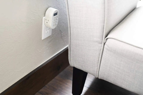 Smooth Operator Indoor Plug In Digital Timer With Two Grounded Outlets And Sunsmart Sunrise Sunset Tracking For Zero Hassle Weekly Scheduling Slick White Build attached to wall near sofa.