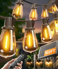 Close-up of 102Ft Solar String Lights With Remote Waterproof Outdoor Patio Garden Lights 32 Shatterproof LED Bulbs glowing at night.