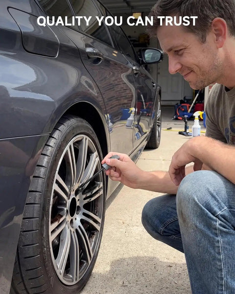 Man using Premium Wheel Touchup Paint For Bmw Jet Black Alloy Rims on a rim to repair scratches.