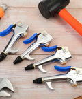 Four Piece Lever Blow Gun Set With Rubber Tip Nozzles And Safety Tips on wooden surface with tools