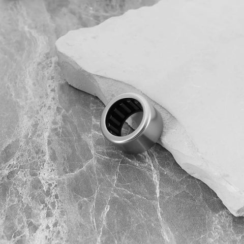 2 Pcs TA1715Z Needle Roller Bearings 17mm By 24mm By 15mm Precision Steel Bushings on a stone surface.