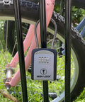 Heavy Duty Combination Key Box With Rolling Dial Mechanism For Outdoor Home Security mounted on a bike rack securing a bike.