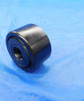Rock Solid Cam Yoke Roller Bearing With Lubri Disc Seal 1 3/4 Inch Outer Diameter and Half Inch Inner Bore on blue background.