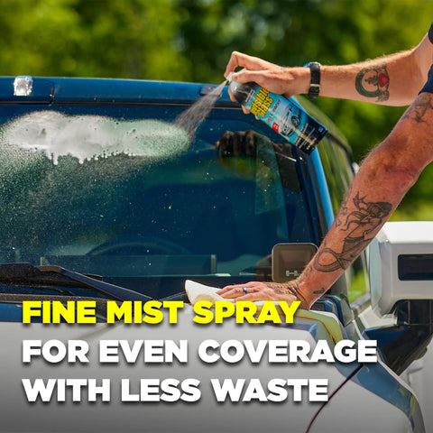 Person using Top Shelf Foaming Auto Glass Cleaner on windshield for streak-free shine, 19 ounce spray can in hand.