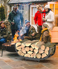 Beefy Firewood Rack For Outdoor Use, 29 Inch Log Holder, Black Steel Frame, near outdoor fire pit with people gathered.