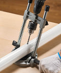 Pro Grade Multi Angle Drill Guide Jig For Woodworking Portable Precision Drilling Guide With 45 Degree 60 Degree 75 Degree 90 Degree Settings Aluminum Alloy Build Large Handle Mounting Holes For Accurate Angled Or Straight Holes drilling into a wooden surface.