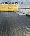 Heavy Duty Six Inch 8 Gauge Galvanized Landscape Staples securing black weed barrier fabric in greenhouse