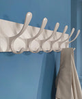 Wooden Wall Coat Rack With Six Hooks White Finish Modern Space Saving Wall Hanger mounted on blue wall holding coat