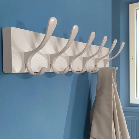 Wooden Wall Coat Rack With Six Hooks White Finish Modern Space Saving Wall Hanger mounted on blue wall holding coat