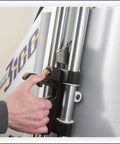 Close-up of hand adjusting the clamp on the Shop Grade Wall Mount Machine Cutter Rig for precise cutting.