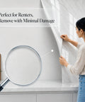Person applying Marble Look Peel And Stick Contact Paper 39 Inch By 118 Inch White Vinyl Wallpaper for countertop surface.