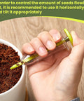Person using Six Piece Mini Seed Dispenser Kit With Two Transplanting Tools And Seed Planter for precise sowing, fluorescent yellow.