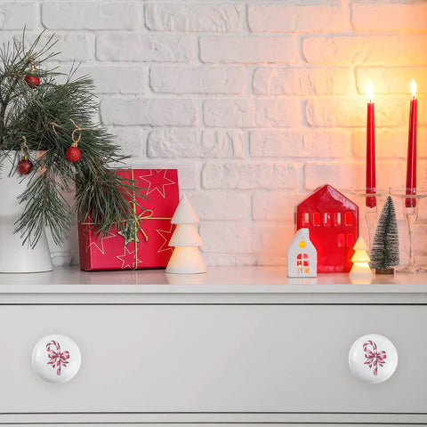 Festive Peppermint Ceramic Knob Covers For Cabinets And Drawers Super Easy Install Holiday Home Refresh Essentials decorative knob on white drawer.
