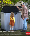 Store It Out Prime Outdoor Resin Storage Shed With Hydraulic Pistons shown in a backyard setting with a man and child.
