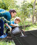 Person and child using Heavy Duty Weed Barrier Landscape Fabric 3ft x 10ft Ground Cover For Outdoor Gardens And Flower Beds Weed Block Mat