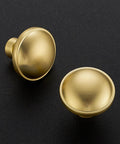 Rock Solid Zinc Alloy Cabinet Pulls Featuring A Slick Brushed Gold Finish 1 1/4 Inch Diameter Heavy Duty Kitchen Hardware Ultimate Upgrade Dreamy Cabinet Knobs 5 Pack Set Premium Corrosion Resistant Build For Long Lasting Beauty Everyday Use In Every Room. Close-up of brushed gold cabinet knobs on dark background.