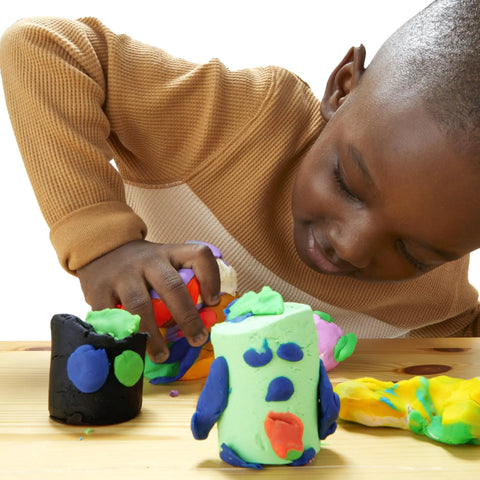 Child crafting with colorful modeling clay from the Game Changing Modeling Compound Haul With 65 Mini Cans.