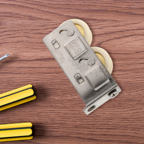 Heavy Duty Stainless Steel Sliding Door Window Pulley Roller Replacement Runs Smooth As Butter Track Wheel Guide for Interior Cabinets on wooden surface.
