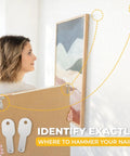 Woman using All In One Picture Hanging Kit With Level Tool And Sawtooth And Wire Hangers for precise wall mounting