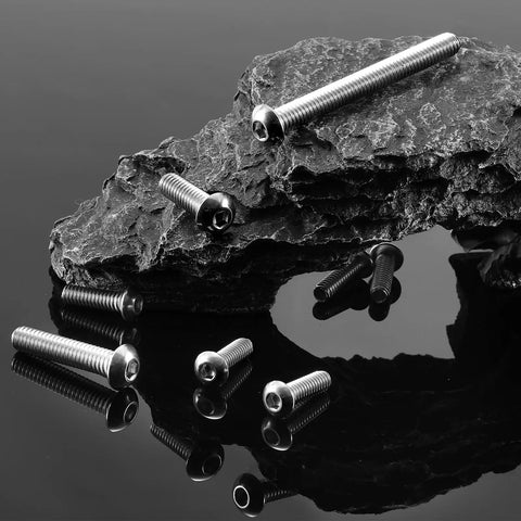 One Quarter Inch Twenty By Three Eighth Button Head Socket Cap Screws Type 304 Stainless Steel on rock surface.