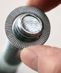 Ironclad 316L Stainless Steel Wedge Locking Washers For 1/4 Inch Bolts, Glued Rattle-Free Pairs on a bolt.