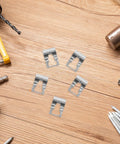 Top Tier 5Pc Windshield Wiper Linkage Repair Clamp Kit Boasting Easy Snap Install, five steel clips on a wooden surface.