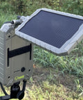 Portable 2 In 1 Solar Panel And Rechargeable Battery Pack For Trail Cameras mounted outdoors, showing solar panel and casing.
