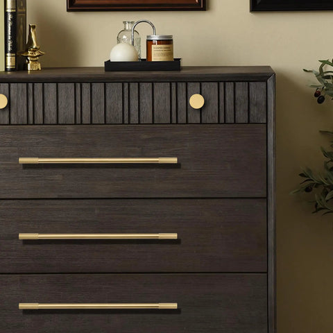 Top Tier Solid Brass Cabinet Pulls With Brushed Gold Finish on dark wooden dresser drawers, modern sleek design.