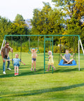 Kids enjoying a backyard swing set with monkey bars, belt swing, platform swing, climbing net, trapeze bar; durable steel frame, powder-coated finish.