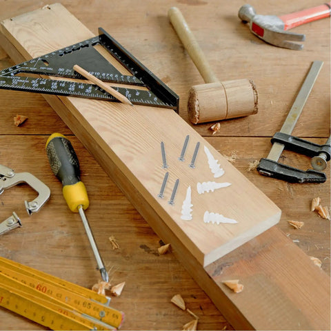 Heavy Duty Wall Anchors Set With Screws for Drywall and Concrete, tools on a wooden surface