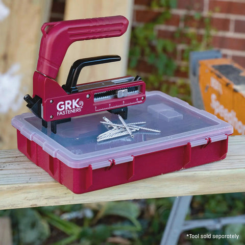 GRK Fasteners tool positioned on a storage box, featuring multiple deck screws, for Premium Hidden Fastening Deck Screws With Killer Grip And Weather Resistant Tan Finish Built For Seamless Outdoor Woodworking Projects And Heavy Duty Backyard Build Outs.
