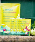 Compost Starter And Odor Reducer Pack That Converts Kitchen Scraps And Yard Waste Into Fertile Humus For All Composting Systems Stops Odors At The Source Includes Four Packets In One Easy No Fuss Package shown on kitchen counter with vegetables