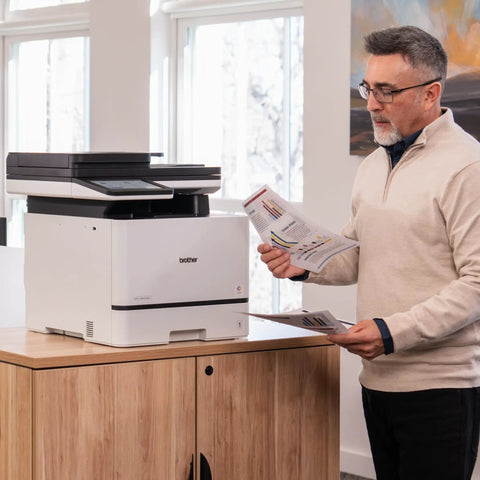 Man using Color Laser All In One Printer With Duplex Printing, Scan And Copy, Fast 33 Pages Per Minute, Compact Durable Design in office