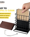 Hand placing suet cake in Outdoor Suet Feeder With Squirrel Proof Hook For Birds All Metal Roofed Cage Feeder Weatherproof