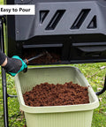 Close-up of 43 Gallon Dual Chamber Compost Tumbler With 360 Degree Tumbling For Fast Aeration And Nonstop Composting Dual Chamber Bin Built To Last For Kitchen Scraps And Yard Waste In Black with compost being poured into a bin.
