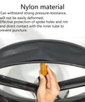 Hand holding Two Pack 26 Inch Rim Strips With 80mm Wide 0.6mm Thick Fat Tire Liner Nylon Inner Tube Cushion Protector Anti Puncture For Bikes Black