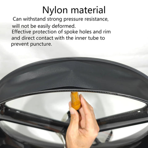 Hand holding Two Pack 26 Inch Rim Strips With 80mm Wide 0.6mm Thick Fat Tire Liner Nylon Inner Tube Cushion Protector Anti Puncture For Bikes Black