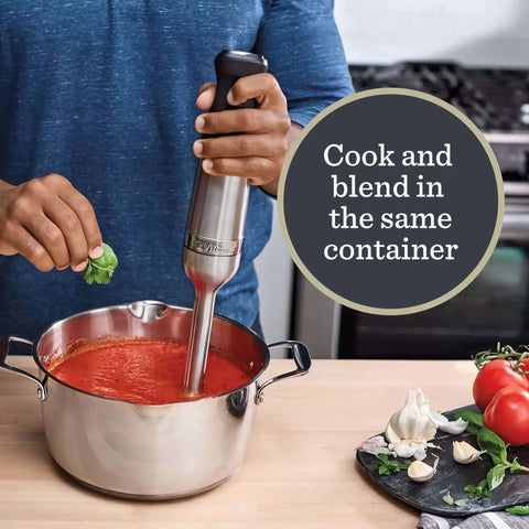 Hella Powerful Immersion Blender With Five Speed Settings And A 625-Watt Motor blending tomato soup in a stainless steel pot.