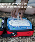 Philips HeartStart AED trainer in blue unit with clear defibrillator pads inside a red zippered carry case